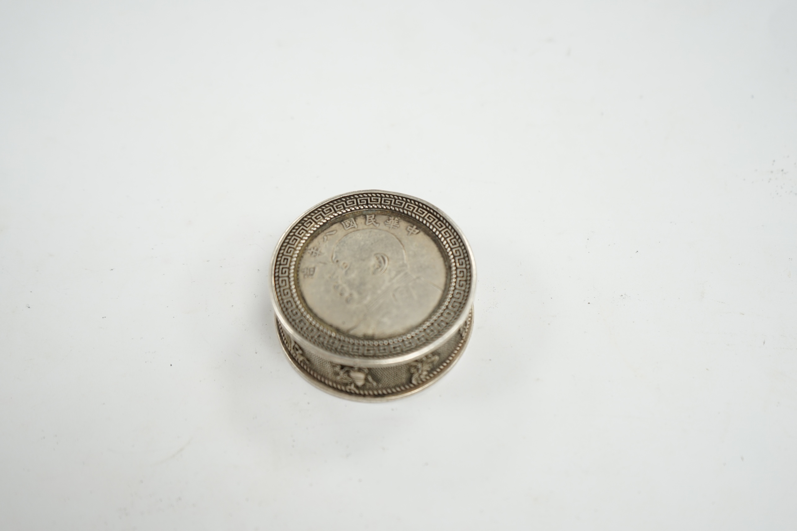 A Chinese white metal coin box and stamps, coin box 5cm diameter. Condition - coin box interior marked, stamps appear fair